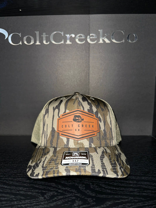 OG Colt Creek Co. Bottomland Camo Leather Patch Trucker